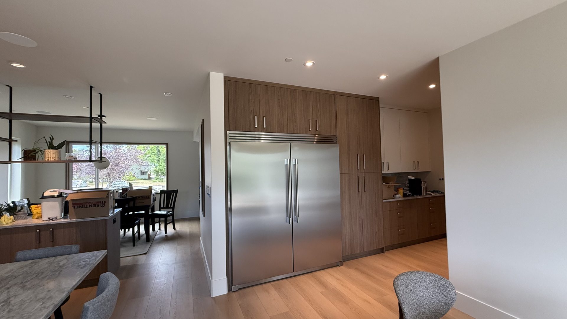 The new kitchen with walnut-toned cabinetry and a built-in stainless fridge
